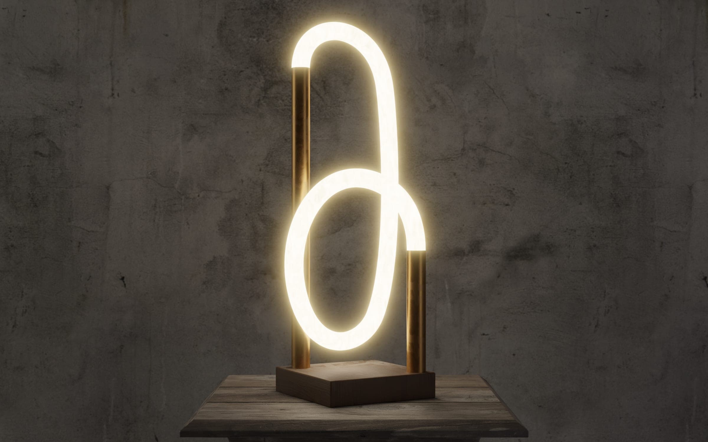 Table lamp — a looped light tube held between brass posts, against concrete